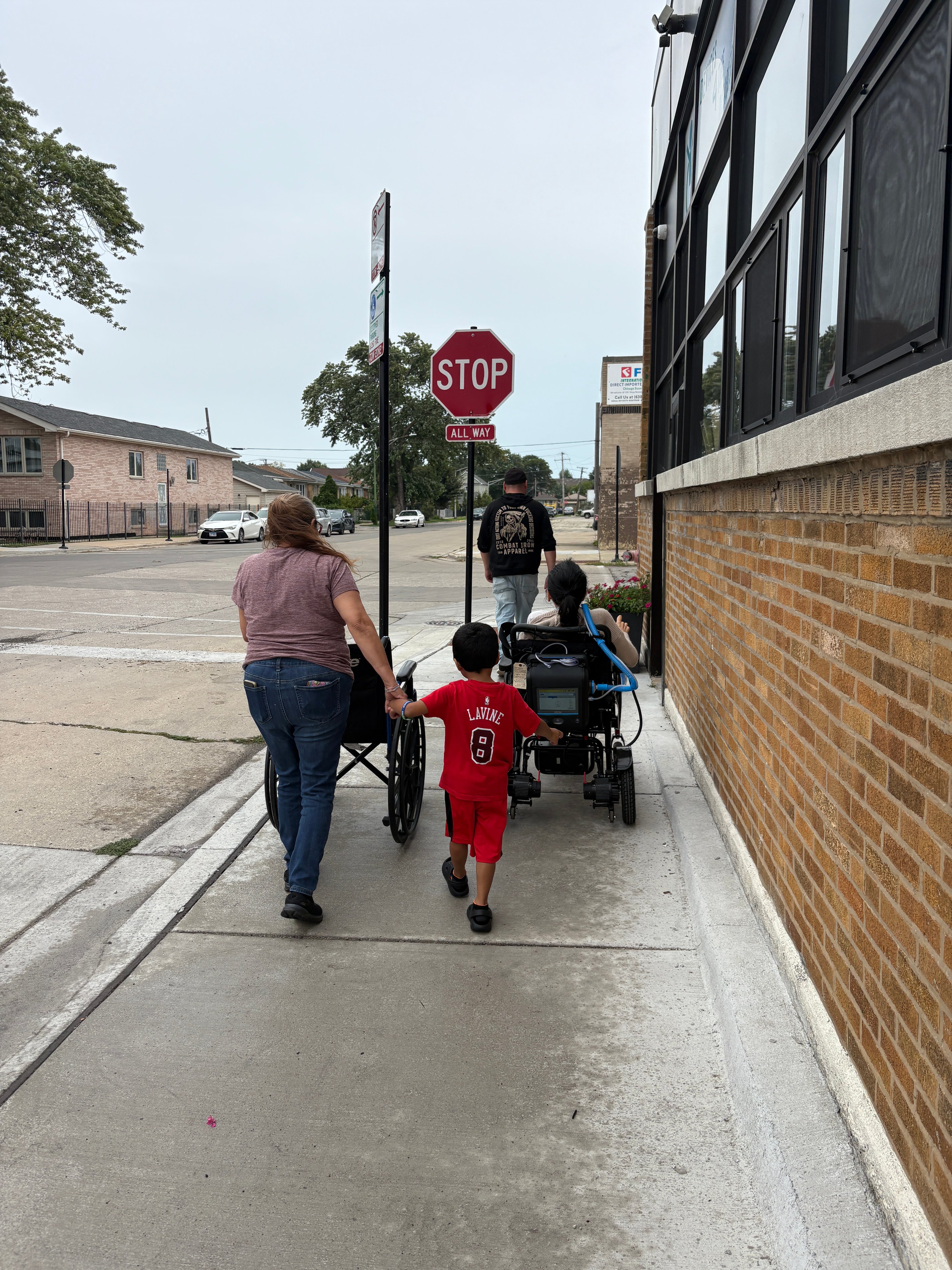 Maria leaving Devices 4 the Disabled in her new wheelchair with her family by her side.